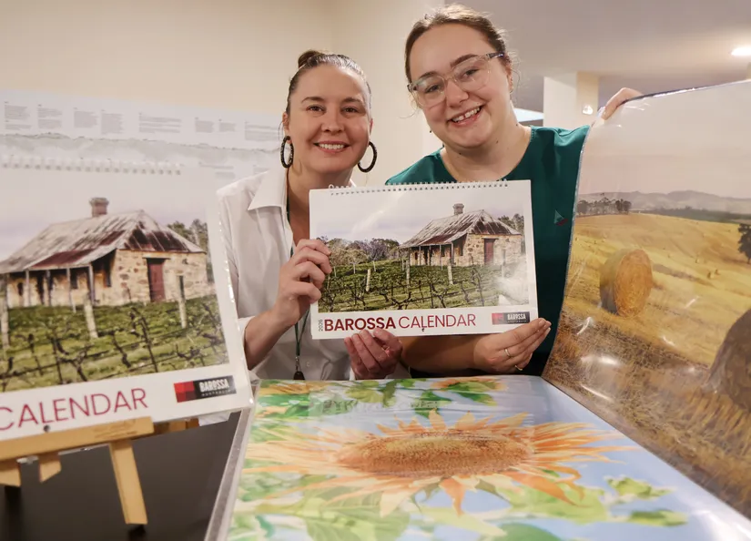 Megan and Bridget with last year's photographs and calendar