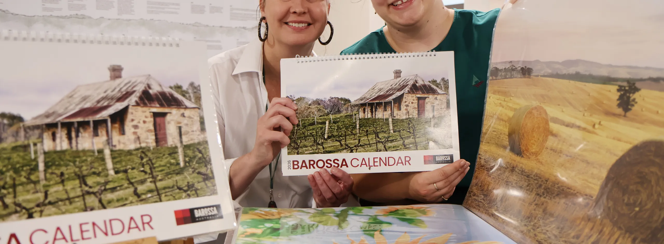 Megan and Bridget with last year's photographs and calendar