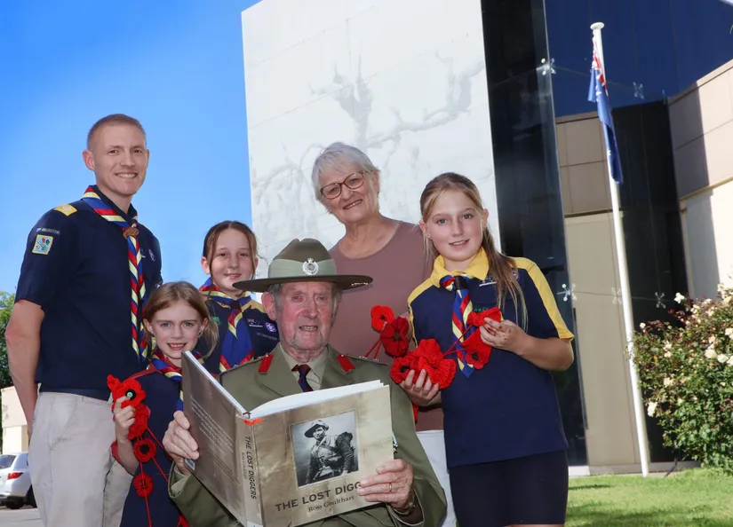 Three young scouts, their scout leader, and RSL member wearing uniform and medals and a local historian standing in front of the Barossa Council office
