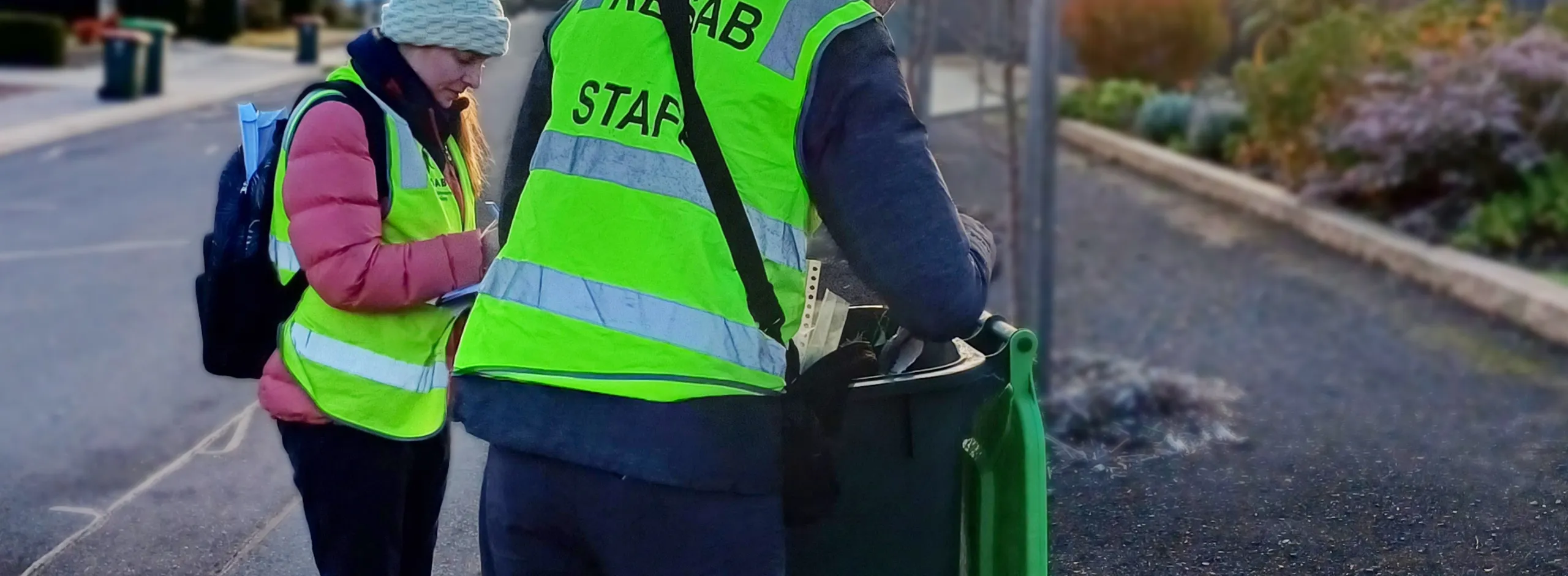 KESAB employs lifting the lid on a green bin located beside a road ready for pick up