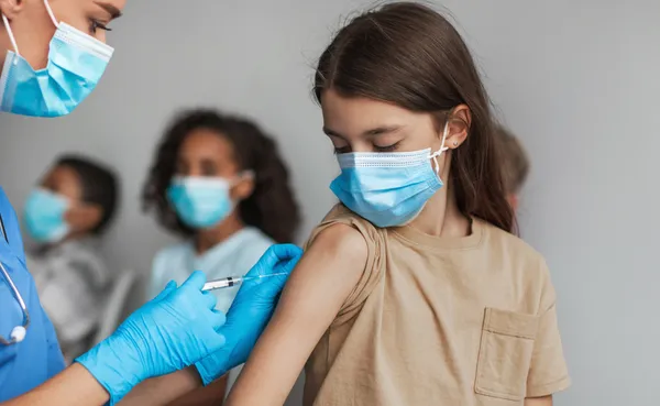 Child receiving immunisation shot