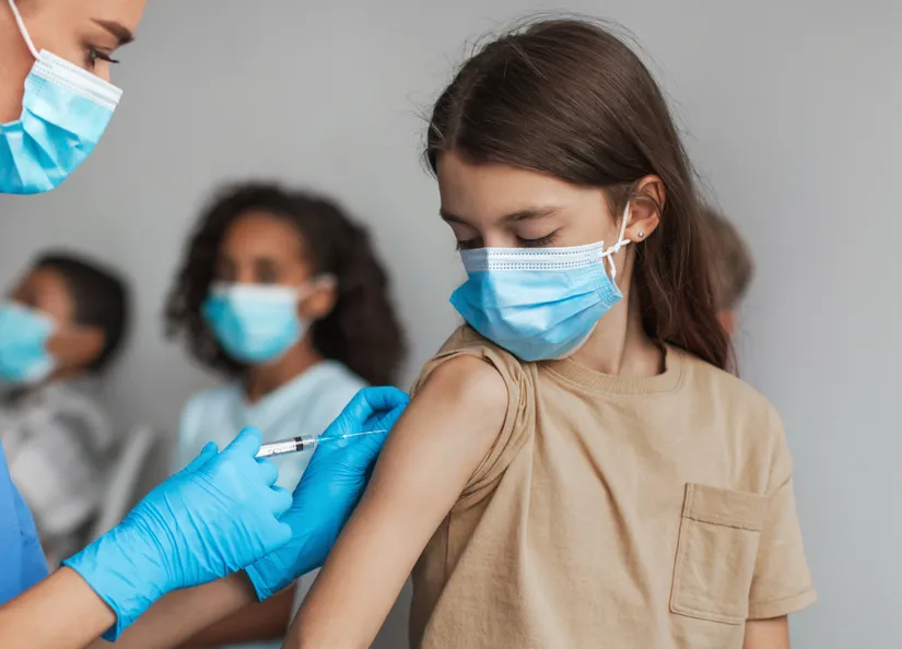 Child receiving immunisation shot