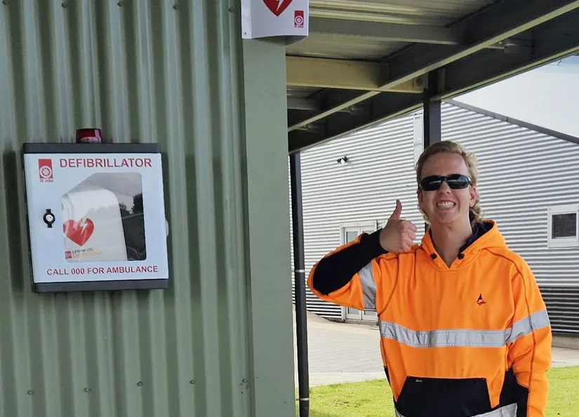 Council staff member giving the thumbs up after installing a defibrillator