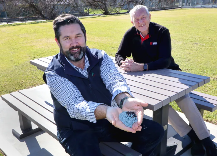 Glen Carter and Mayor Bim Lange with new furniture and a handful of pellets from which the product is made.