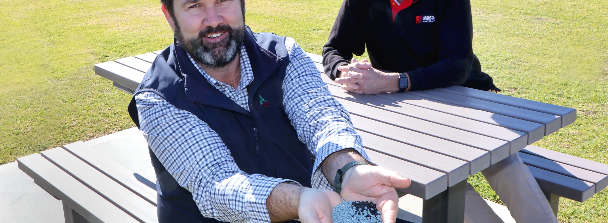 Glen Carter and Mayor Bim Lange with new furniture and a handful of pellets from which the product is made.