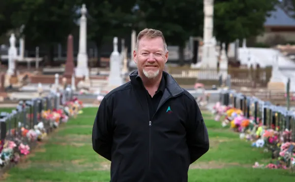 The Barossa Council's grave digger standing in the middle of a cemetery