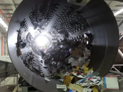 Materials are sorted in a trommel at recycling facility