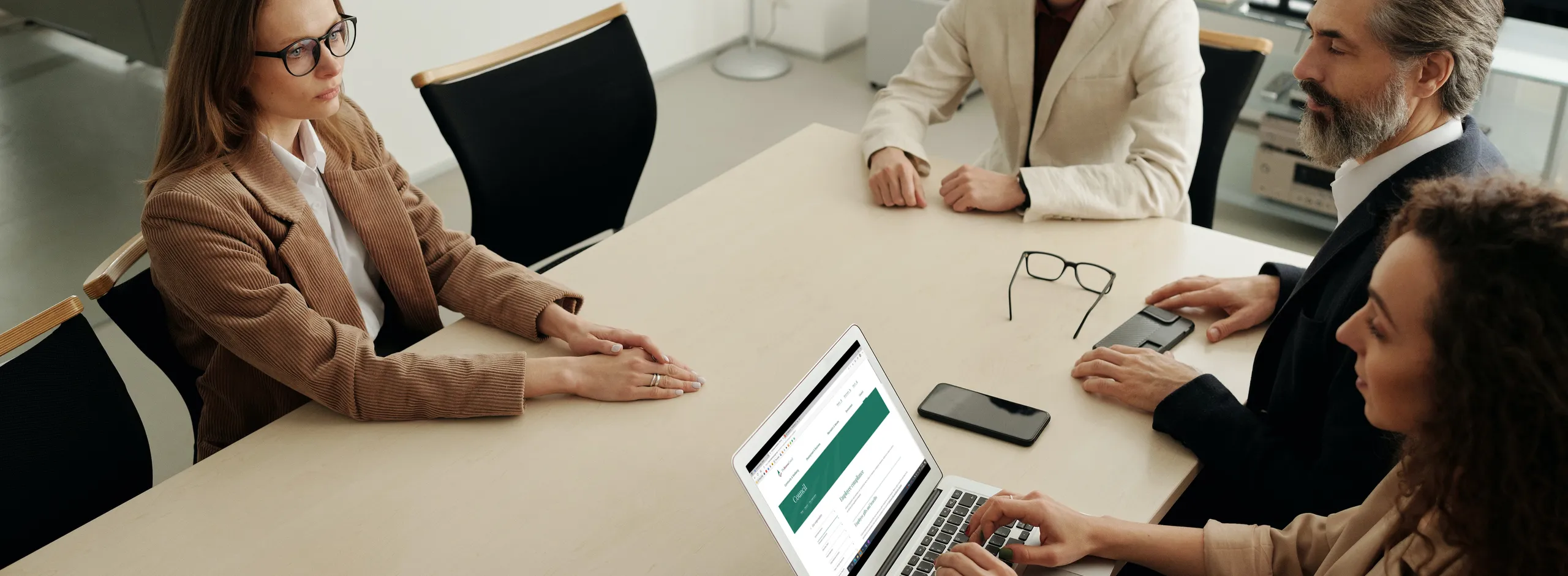 Woman using Mac Book Air during the meeting Employee Compliance