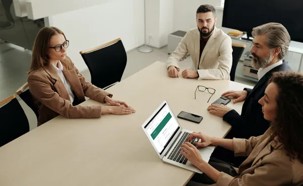 Woman using Mac Book Air during the meeting Employee Compliance