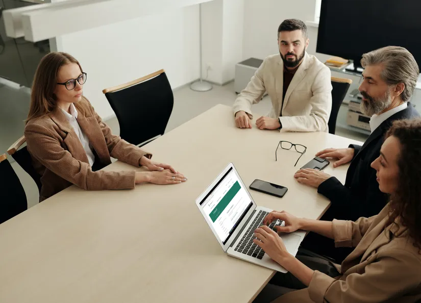 Woman using Mac Book Air during the meeting Employee Compliance