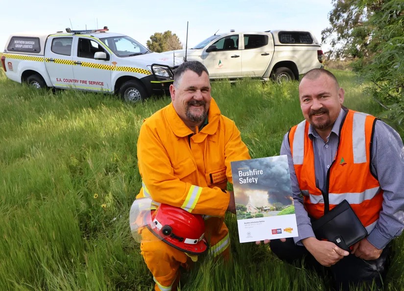Shaun Falkenberg, Nuriootpa CFS with Council's John Armstrong in a field of high grass