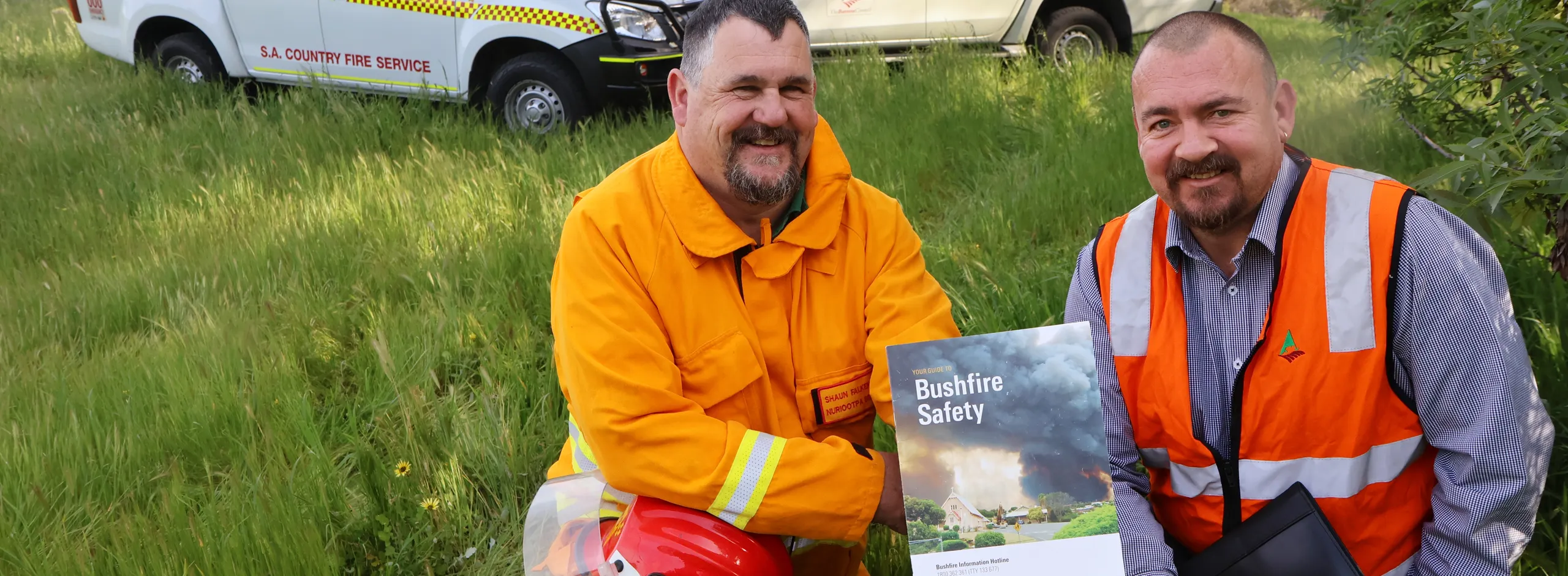 Shaun Falkenberg, Nuriootpa CFS with Council's John Armstrong in a field of high grass