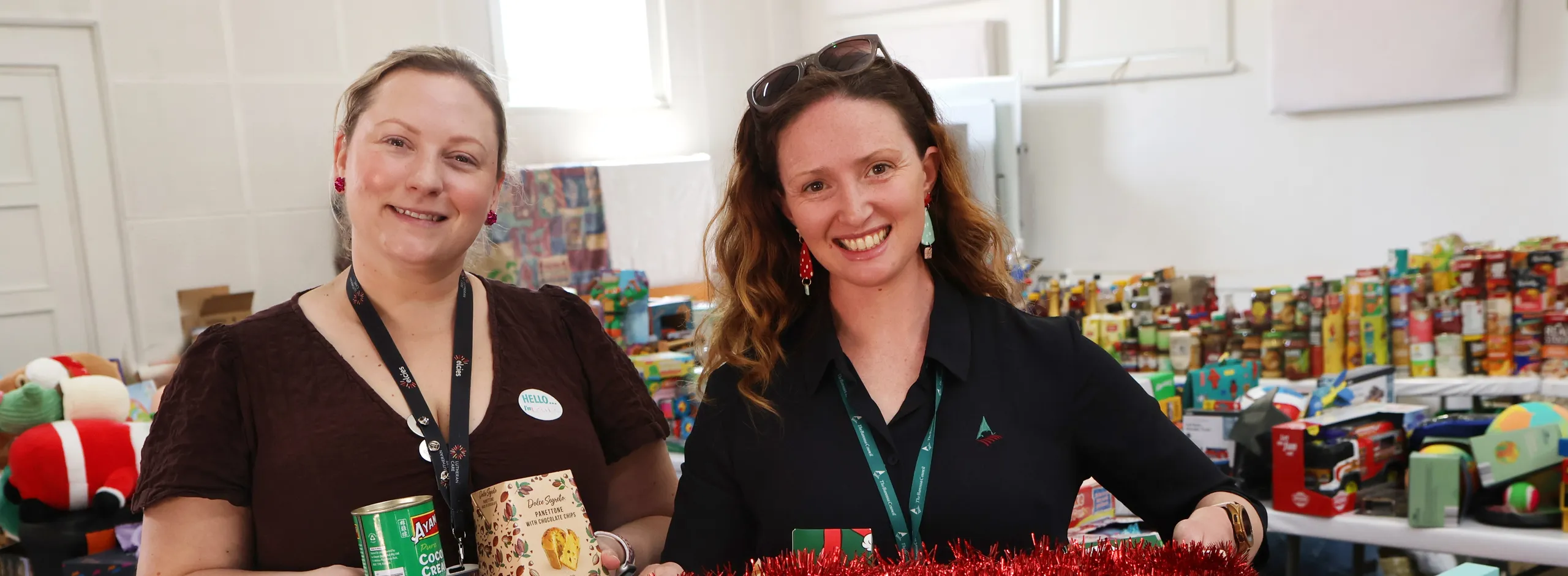 Louise and Stacy in a room filled with donations