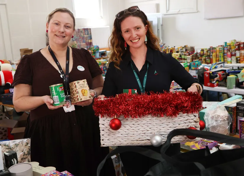 Louise and Stacy in a room filled with donations