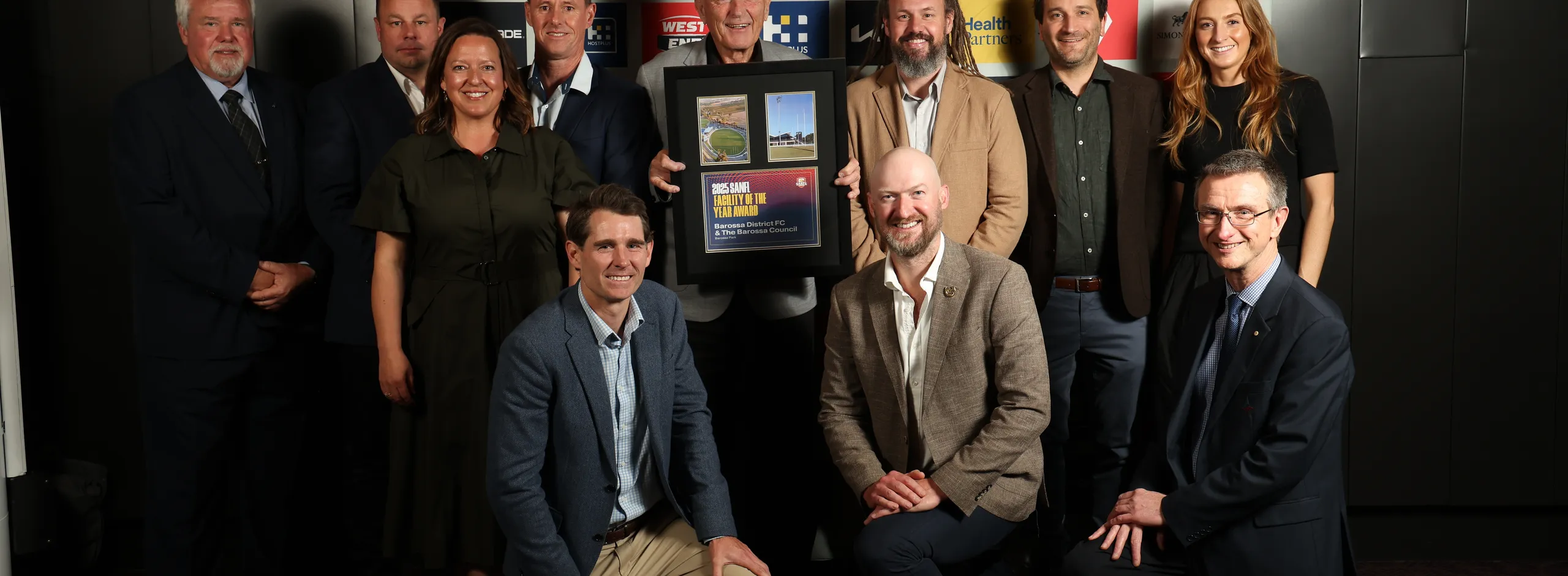 Group of eleven people, including Mayor Bim Lange, with the award.